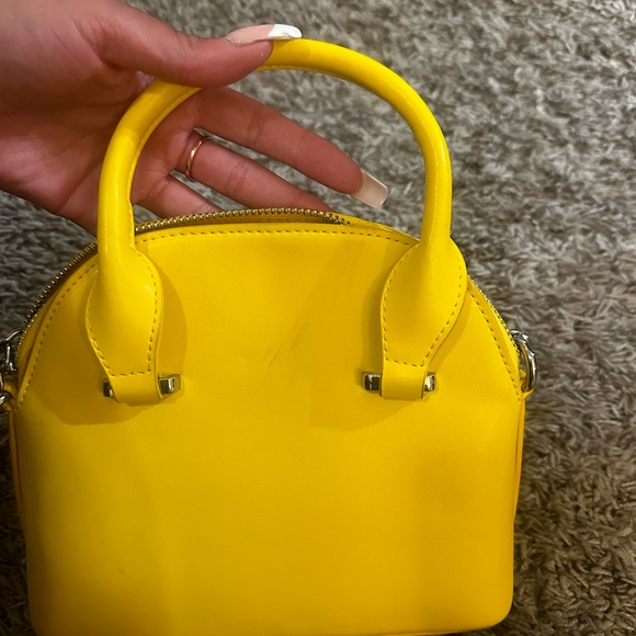 Yellow shoulder bag with silver hardware and zipper closure. - Picture 2 of 6